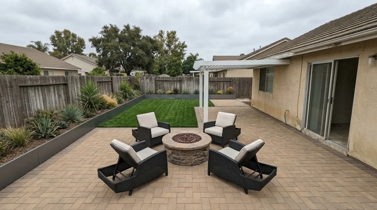 Same backyard after: paver patio, fire pit, patio cover and lawn